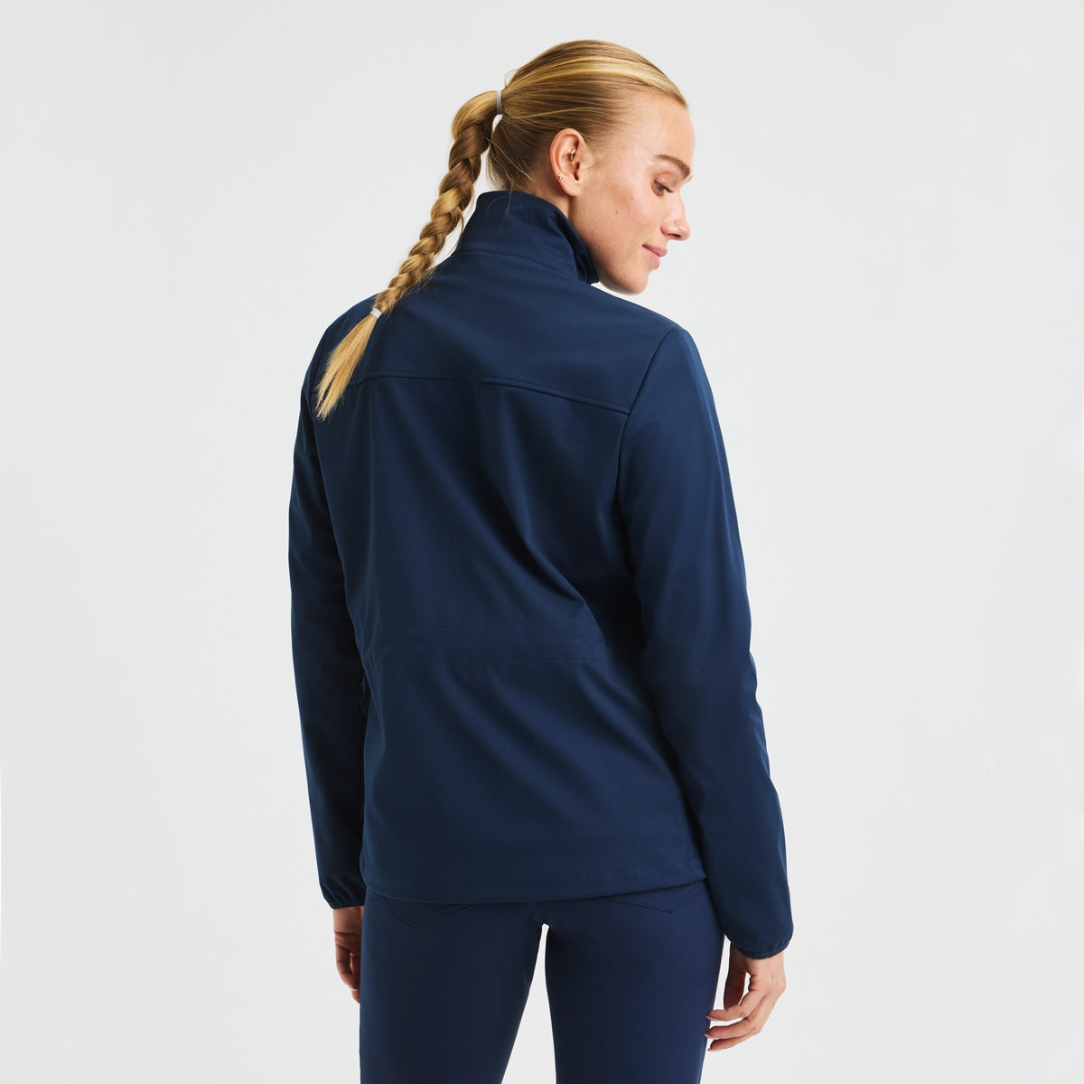 Röhnisch Lorraine women's windstopper jacket, lightweight and breathable, shown in a close-up of the navy blue windproof outer layer.