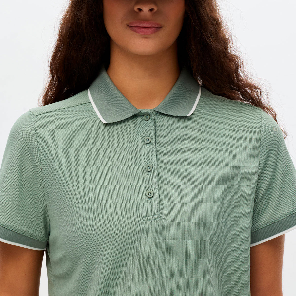 Röhnisch Miriam polo for women, featuring a stylish design in a soft fabric, displayed on a mannequin with a neutral background.