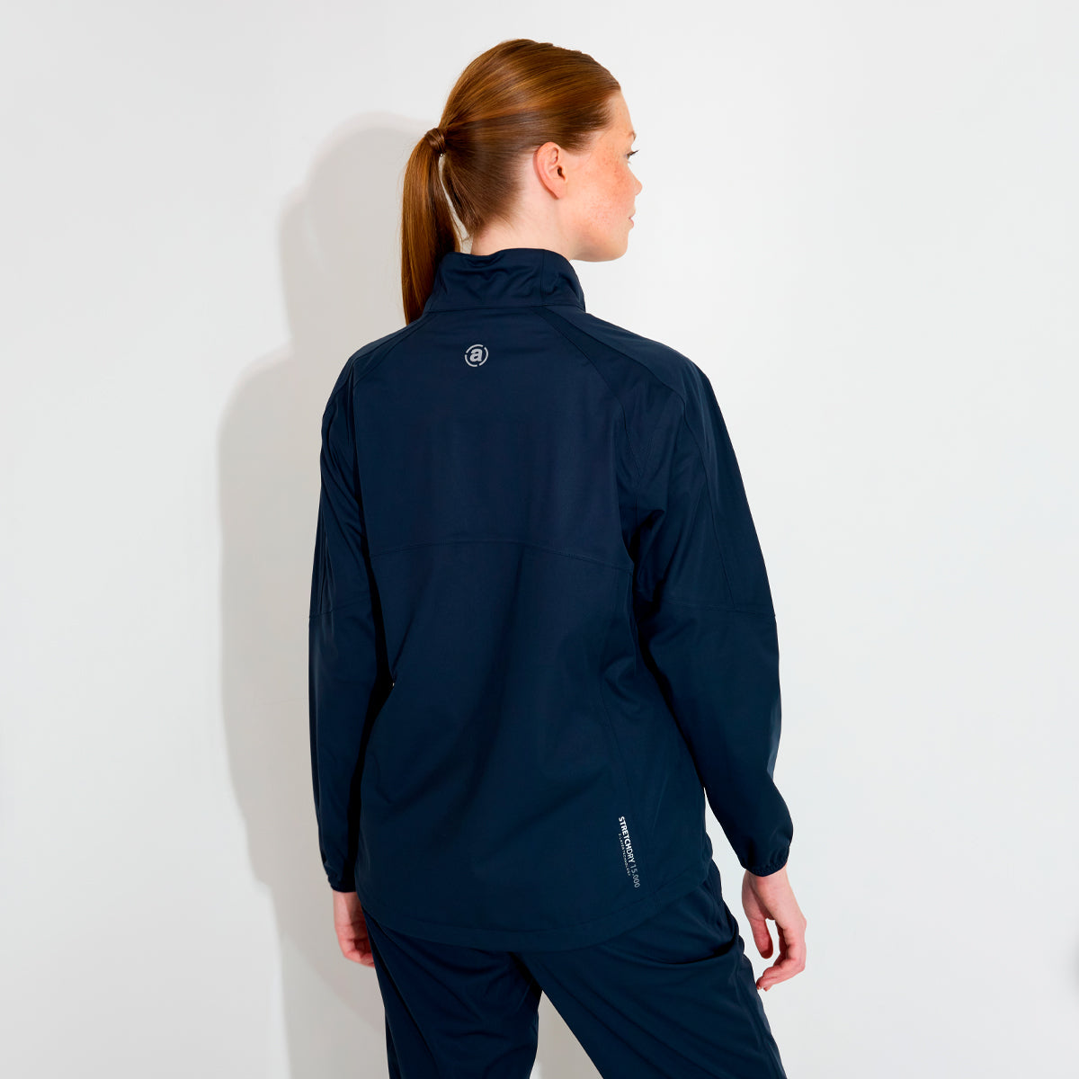 Abacus women's rain jacket featuring a sleek design and functional hood, perfect for outdoor activities.